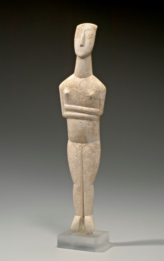 The female figure is displayed in a standing position with pointed feet and folded arms. Anatomical forms are minimal and stylized.